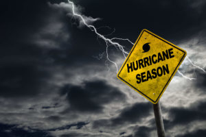 Hurricane season sign with lightning and thunder behind it
