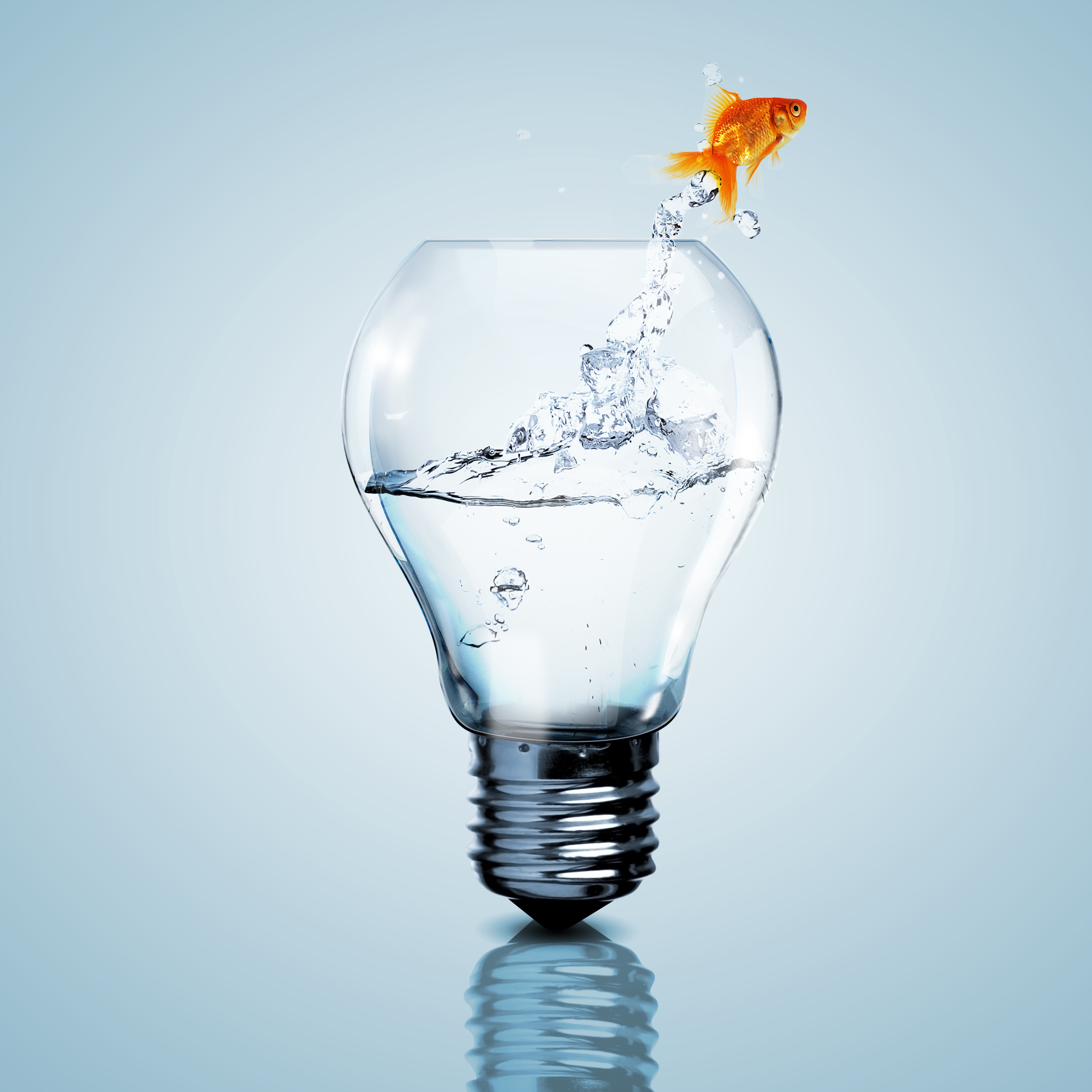 Goldfish leaping from a fish bowl shaped like a lightbulb
